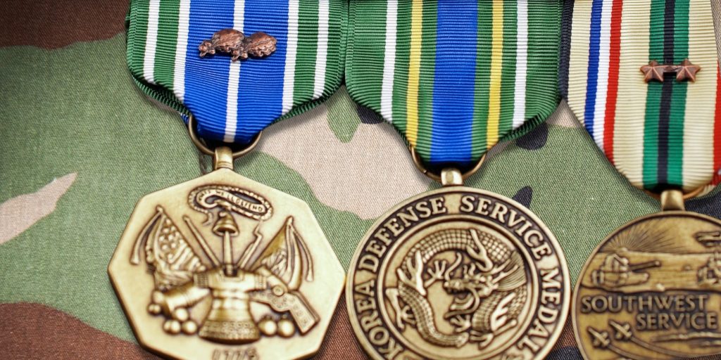 closeup of army medals on uniform