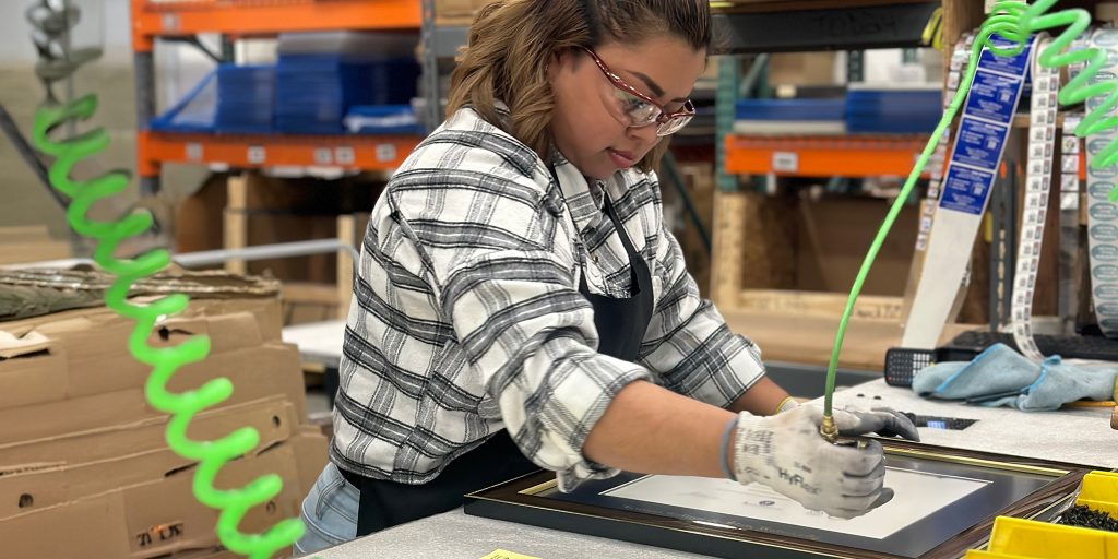 woman manufacturing a custom military frame in a U.S. facility