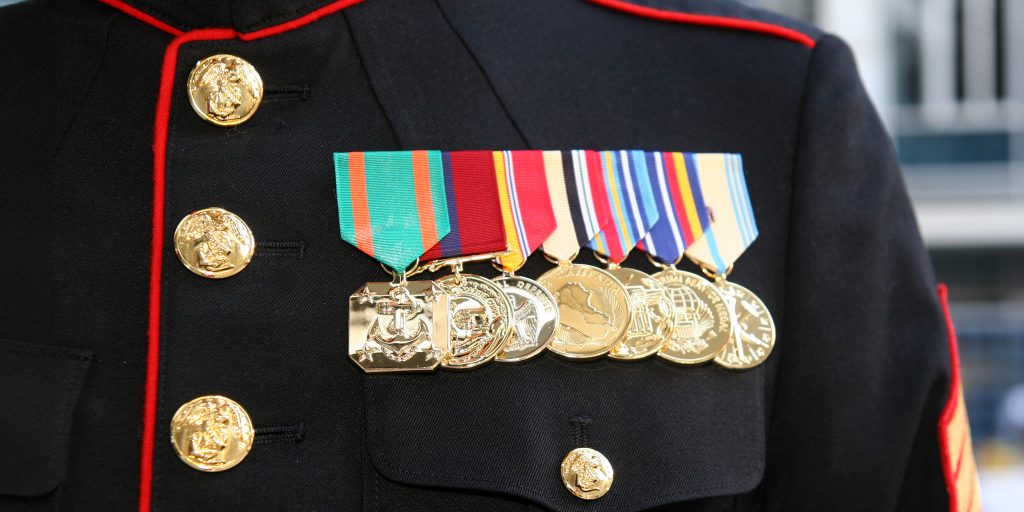 close up view of stack of military medals displayed on soldier's uniform